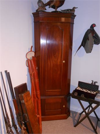 A MAHOGANY 6 GUN SAFE DISGUISED AS A CORNER CABINET